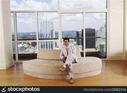 Portrait of a businessman sitting on a couch in an office