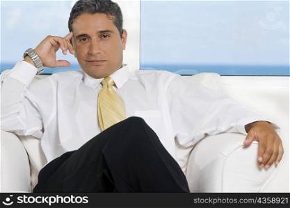 Portrait of a businessman sitting on an armchair