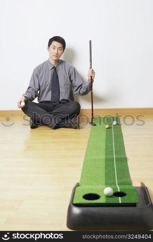 Portrait of a businessman sitting on the floor