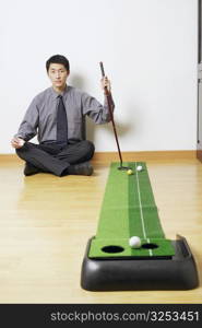 Portrait of a businessman sitting on the floor