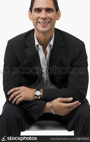 Portrait of a businessman sitting with his arms crossed