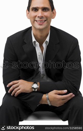 Portrait of a businessman sitting with his arms crossed