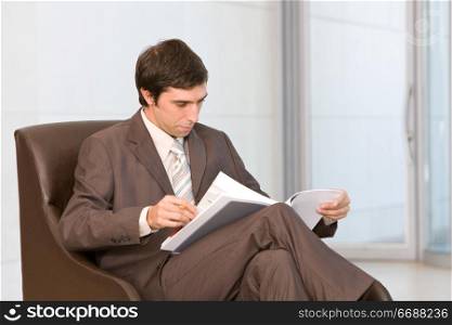 portrait of a businessman sitting with laptop