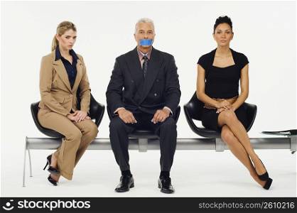 Portrait of a businessman sitting with two businesswomen