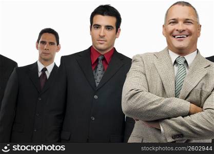 Portrait of a businessman smiling and three businessmen standing behind him