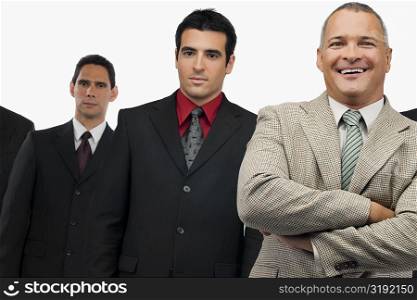 Portrait of a businessman smiling and three businessmen standing behind him
