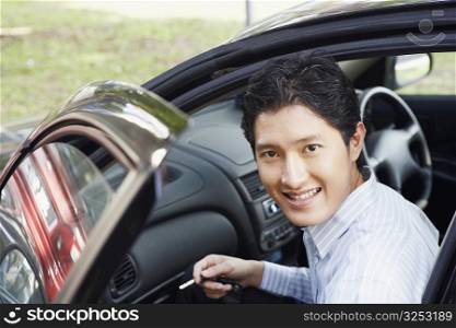 Portrait of a businessman smiling in a car