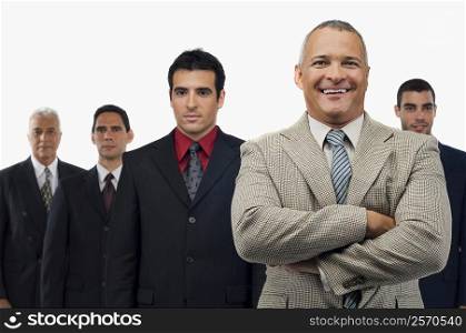 Portrait of a businessman smiling with four businessmen standing behind him