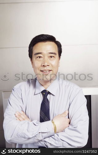 Portrait of a businessman smiling with his arms folded