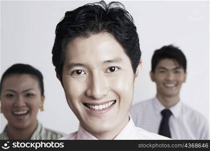 Portrait of a businessman smiling with his colleagues in the background