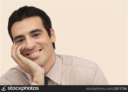 Portrait of a businessman smiling with his hand on his chin