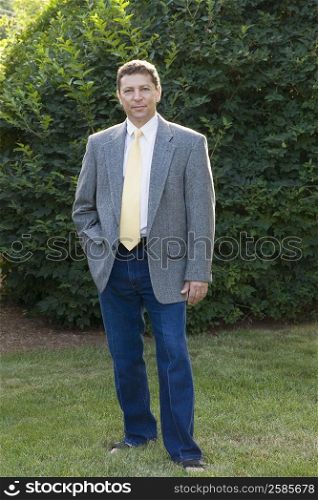 Portrait of a businessman standing in a garden