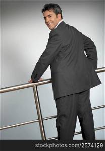 Portrait of a businessman standing near a railing