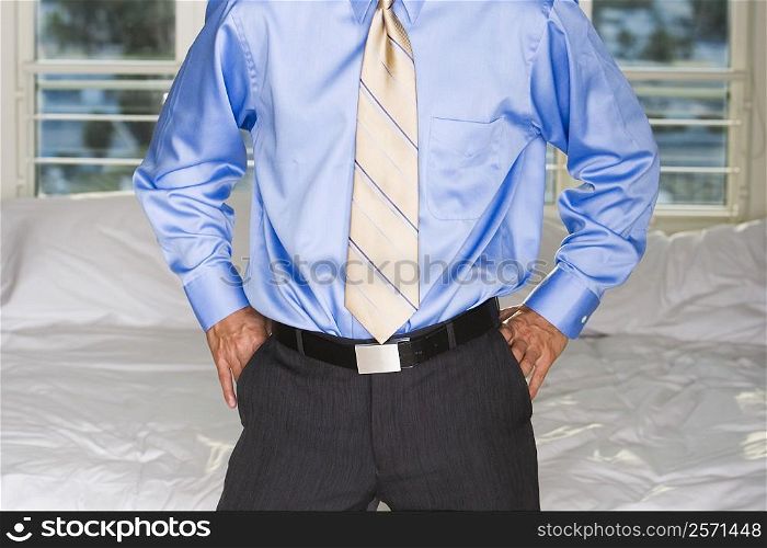 Portrait of a businessman standing with his hands in his pockets