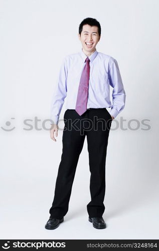 Portrait of a businessman standing with his hands in his pockets