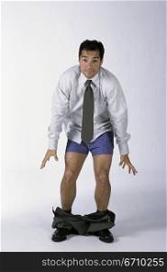 Portrait of a businessman standing with his pants down