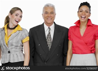 Portrait of a businessman standing with two businesswomen and smiling