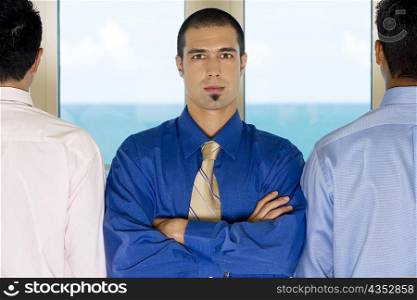 Portrait of a businessman standing with two colleagues