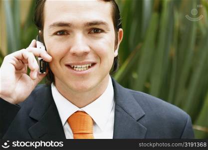 Portrait of a businessman talking on a mobile phone and smiling