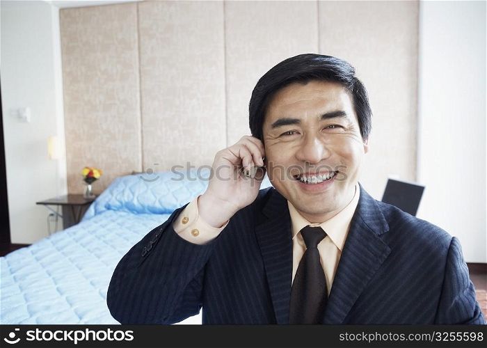 Portrait of a businessman talking on a mobile phone smiling