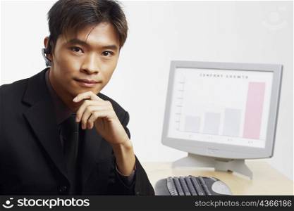 Portrait of a businessman thinking in front of a progress report