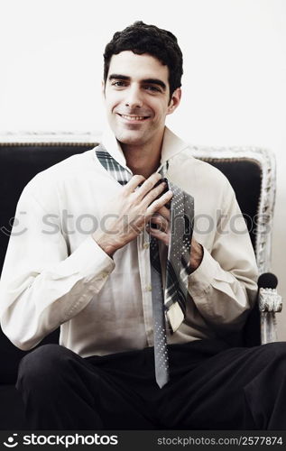 Portrait of a businessman tying his tie