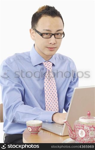 Portrait of a businessman using a laptop