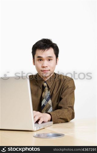 Portrait of a businessman using a laptop