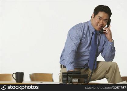 Portrait of a businessman using the telephone