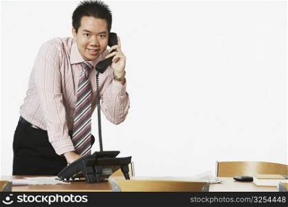 Portrait of a businessman using the telephone