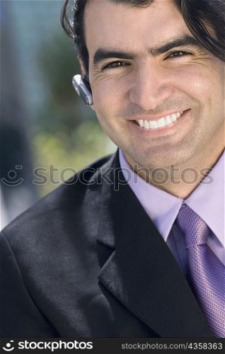Portrait of a businessman wearing a hands free device and smiling