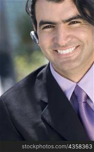 Portrait of a businessman wearing a hands free device and smiling