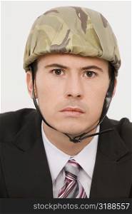 Portrait of a businessman wearing an army helmet