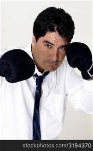 Portrait of a businessman wearing boxing gloves