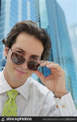 Portrait of a businessman wearing sunglasses and smiling