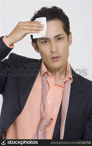 Portrait of a businessman wiping sweat with a handkerchief