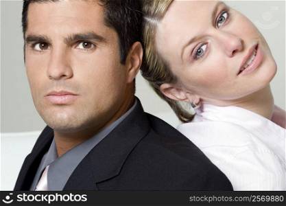 Portrait of a businessman with a businesswoman back to back