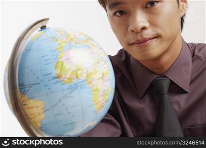 Portrait of a businessman with a globe