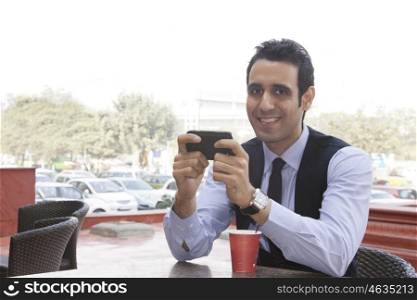 Portrait of a businessman with a mobile phone , INDIA , DELHI