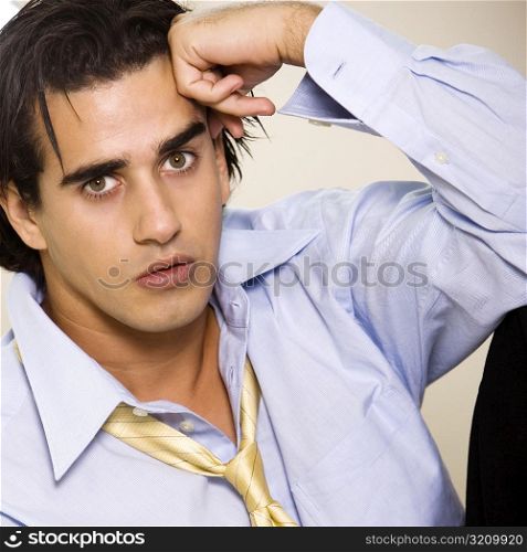 Portrait of a businessman with his hand on his head
