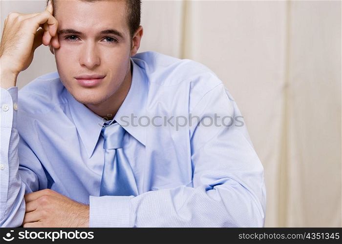 Portrait of a businessman with his hand on his temple