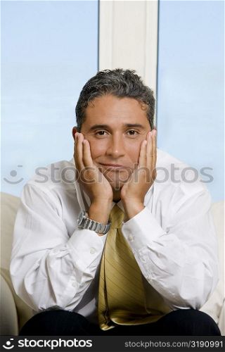 Portrait of a businessman with his hands on his cheeks