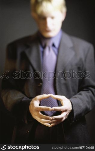 Portrait of a businessman with his hands together