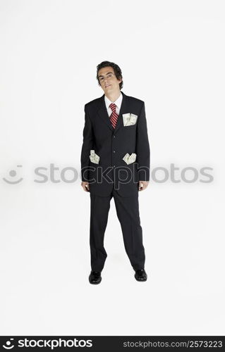 Portrait of a businessman with paper currency in his pockets