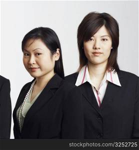 Portrait of a businessman with two businesswomen