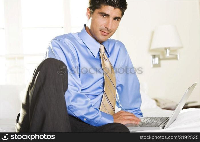 Portrait of a businessman working on a laptop