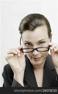 Portrait of a businesswoman adjusting her eyeglasses