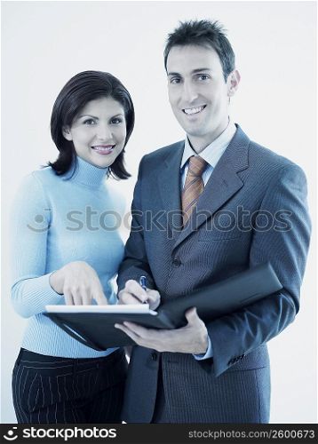 Portrait of a businesswoman and a businessman holding a personal organizer