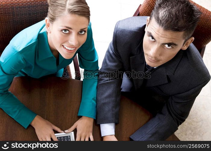 Portrait of a businesswoman and a businessman smiling