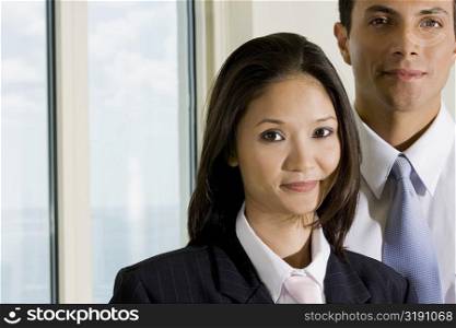Portrait of a businesswoman and a businessman smiling